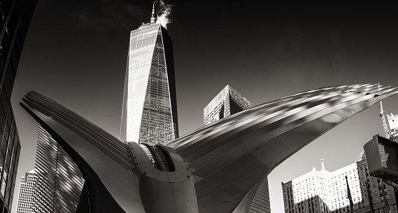 New York City, United States – January 21, 2020: A grayscale shot of the Oculus and the Freedom Tower in the background