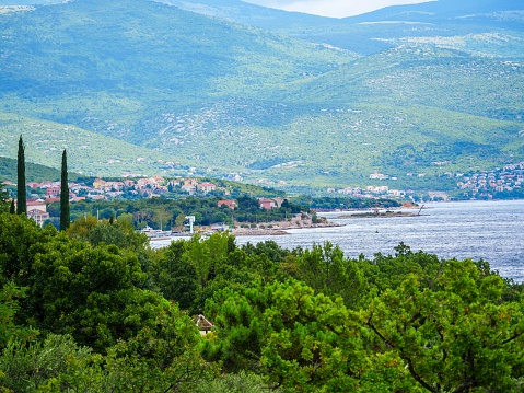 Coastline in Izola Slovenia with green mountains in the background