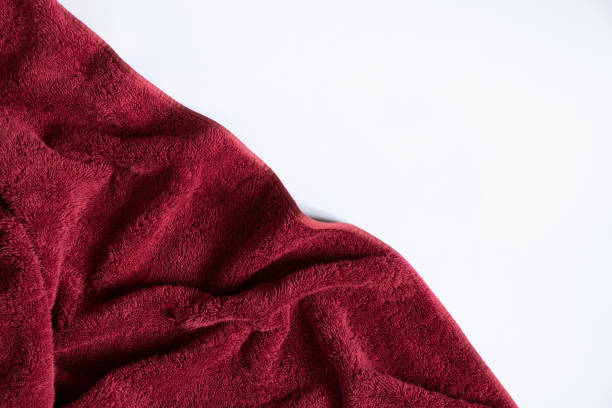 red towel folded lies on a white background, bath red towel stock photo