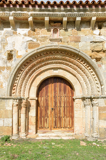 A vertical shot of the main door of Romanesque Church of Quintanarruz in Burgos, Spain