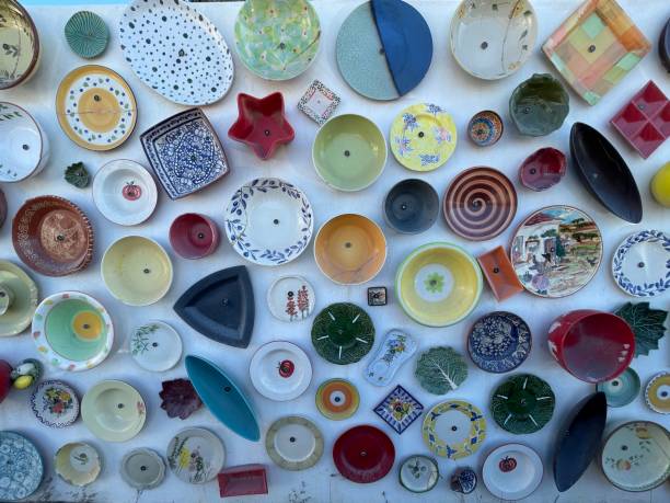 istock Top view of colorful ceramic plates and bowls with unique patterns on a white background 1460724846