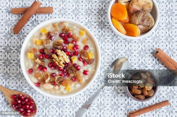 Traditional Turkish Delicious Mixed Dessert Ashura With Pomegranate Seeds Walnut Apricot Noahs Pudding Stock Photo - Download Image Now