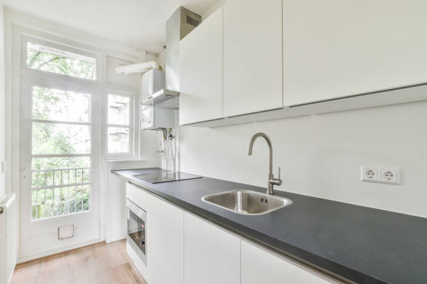 istock Interior shot of a modern kitchen in white tones next to a window 1460725659