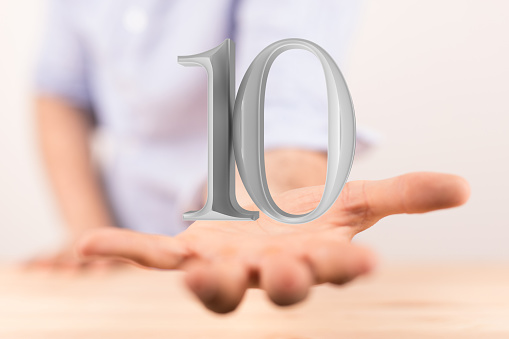 A digital 3d silver number 10 for anniversary, floating on the hand