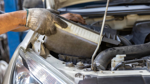 istock Mechanic is checking and change an air filter. Car mechanic working maintenance checking air filter in repair garage. 1460726552