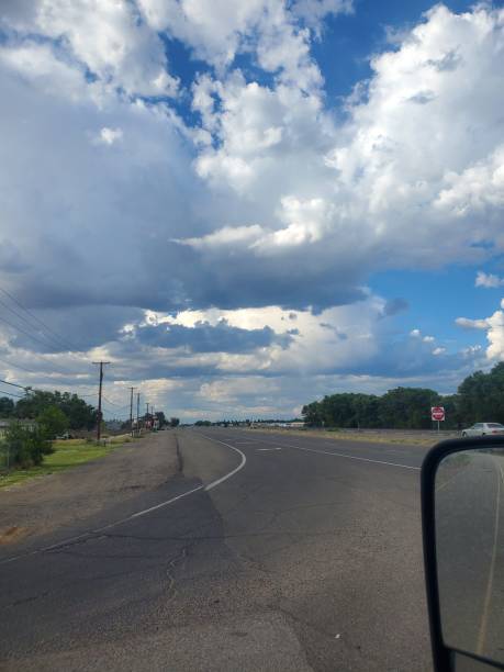 istock Vertical shot of an empty asphalt road under blue cloudy sky 1460726583
