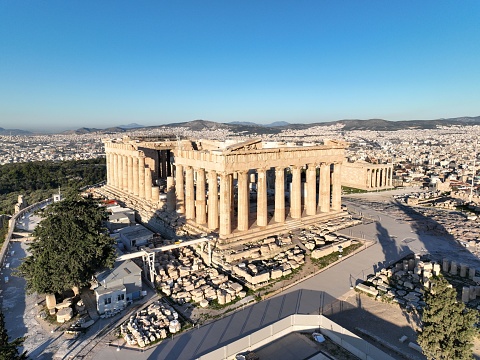 A drone view of the Parthenon on a sunny day in Athens, Greece