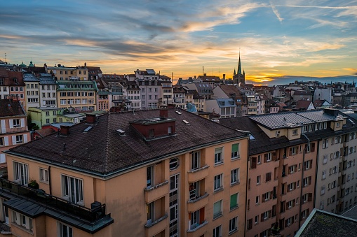 The buildings of Lausanne city in Switzerland with the cathedral and the sunset in the background