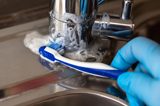 The closeup shot of Removing  limescale with a toothbrush