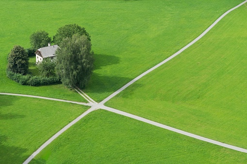 An aerial view of a house in an empty field in Salzburg, Austria