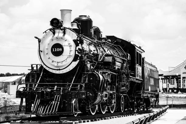 istock Grayscale shot of a train with steam engine on railroad 1460730652