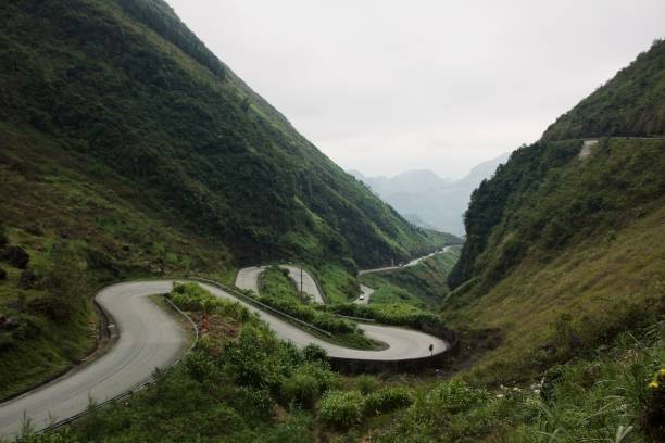 istock Serpentine road in the valley surrounded by greenery 1460731278