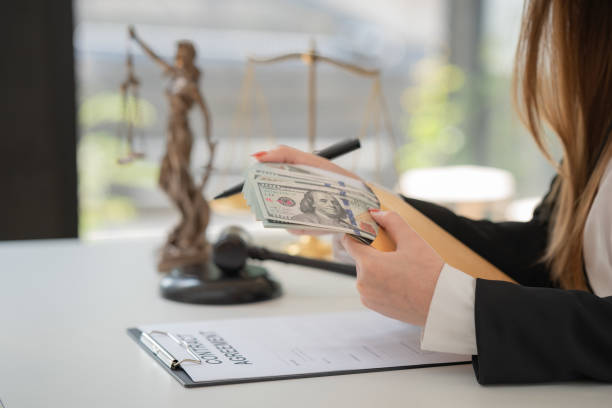 istock Selective focus, a woman offering a batch of hundred dollar bills. Hands close up. Venality, bribe, corruption concept. 1460731284