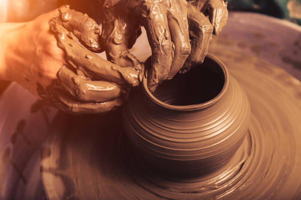 istock Female Hands working on pottery wheel 1460731389
