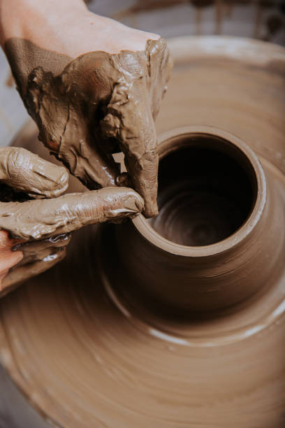 istock Woman hands on pottery wheel 1460731392