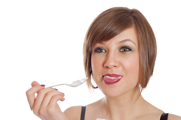 istock Young pretty girl eating yoghurt 146073157