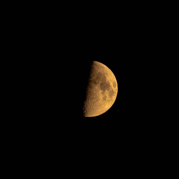 istock Closeup shot of yellow moon eclipse isolated on a black background 1460732018