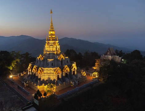 Aerial landscape view (drone photograph) of Sinakarintra Stit Mahasantikhiri Pagoda at night, Doi Mae Salong Khaoi, Chiang Rai, Thailand.
