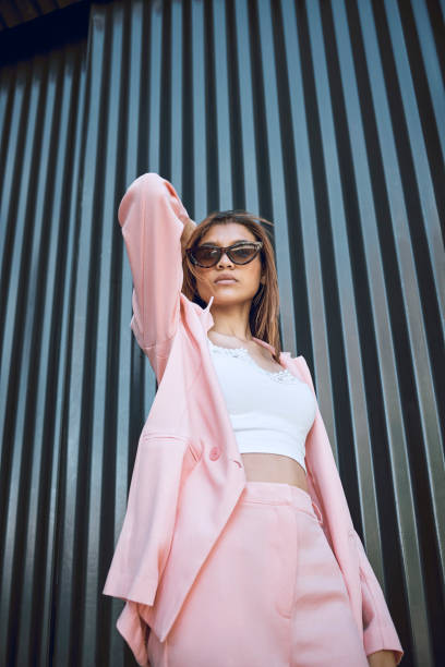 istock A young trendy and confident mixed race woman looking stylish while posing and spending time in the city. Fashionable hispanic woman wearing pink clothes and sunglasses 1460732996
