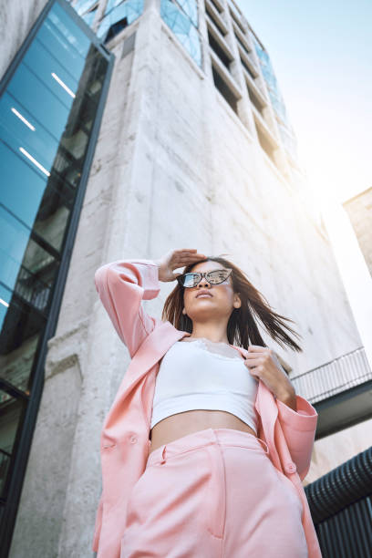 istock A young trendy and confident mixed race woman looking stylish while posing and spending time in the city. Fashionable hispanic woman wearing pink clothes and sunglasses 1460733026