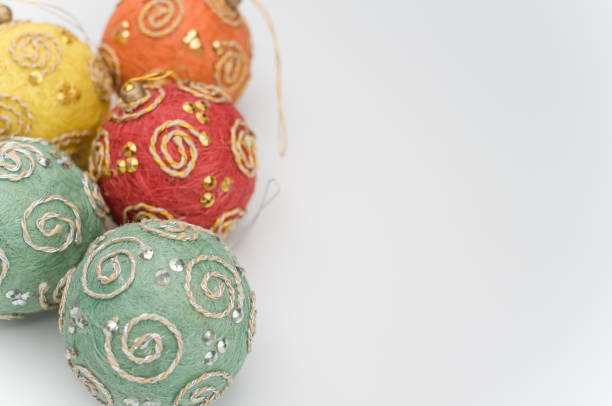 Multicolored Christmas decorative balls with sapce for text on a white surface