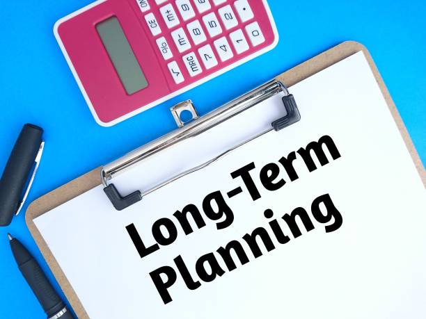istock Long term planning text on paper with pen and calculator 1460735189