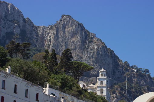 A beautiful view of white buildings and rocks on Capri Island, Naples, Italy