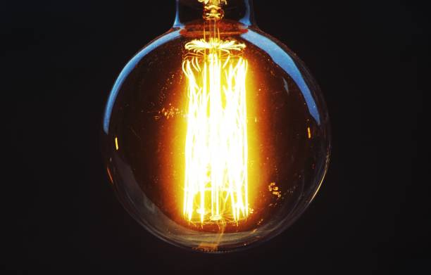 istock Closeup of a lightbulb against a dark background 1460737033