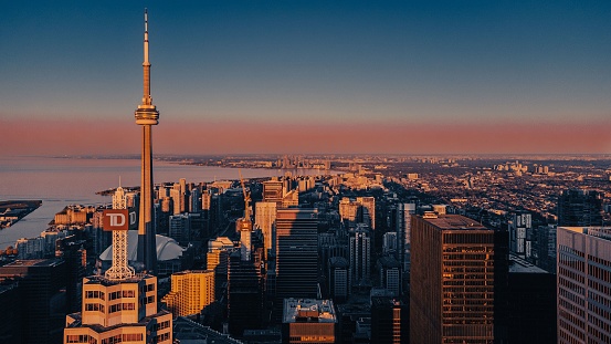 Aerial view of modern cityscape with CN Tower at sunset, Toronto, Ontario, Canada.