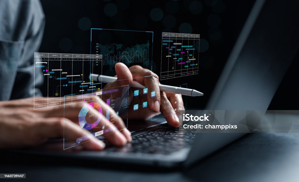 Analyst working with computer in Business Analytics and Data Management System to make report with KPI and metrics connected to database. Corporate strategy for finance, operations, sales, marketing. Adult Stock Photo