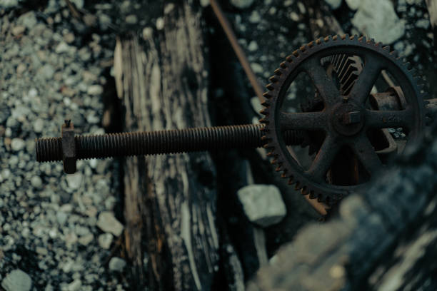 A steel gear in the rubble from a destroyed mechanical dam after a forest fire.