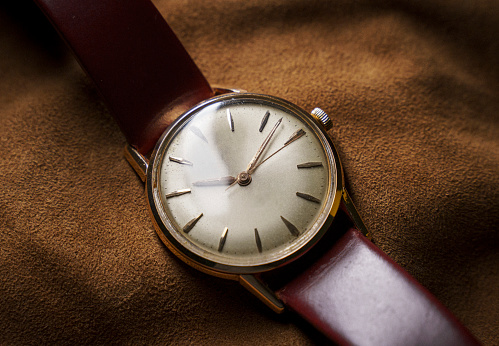 Swiss made vintage automatic watch on brown leather background