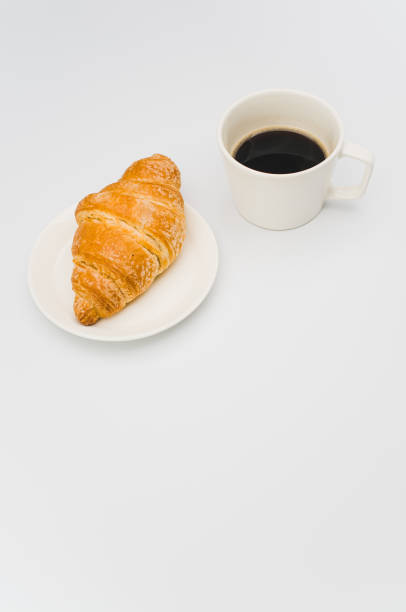 istock fresh and buttery croissant in a plate on a white background 1460740259