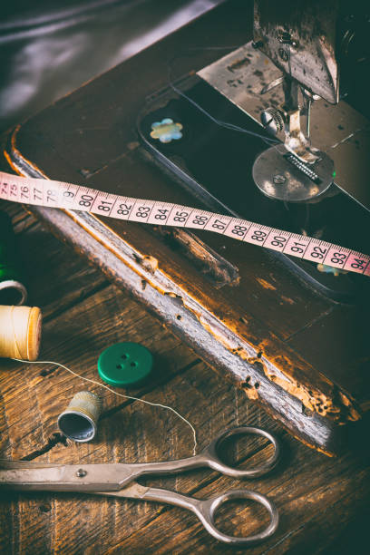 istock Details of a sewing machine, sewing items on a wooden table 1460743780