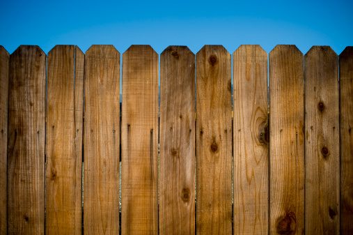 Textured fence with blue sky