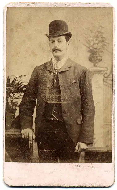Victorian Era's Portrait on a Card (Carte de Visite) - A man with a Bowler hat and Stick, wearing moustach and 3 piece suit. Tipical English Gentleman look. Shot in England circa 1880