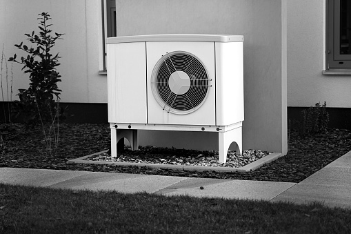 Heat pump reduce living cost in modern house of future, green renewable energy black and white concept of heat pump
