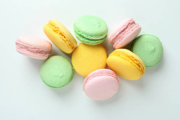 istock Concept of tasty dessert with macaroons on white background 1460748595