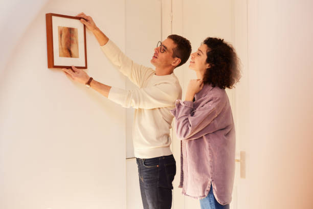 istock Apartment Refresh: Couple Hangs Eye-catching Painting 1460748727