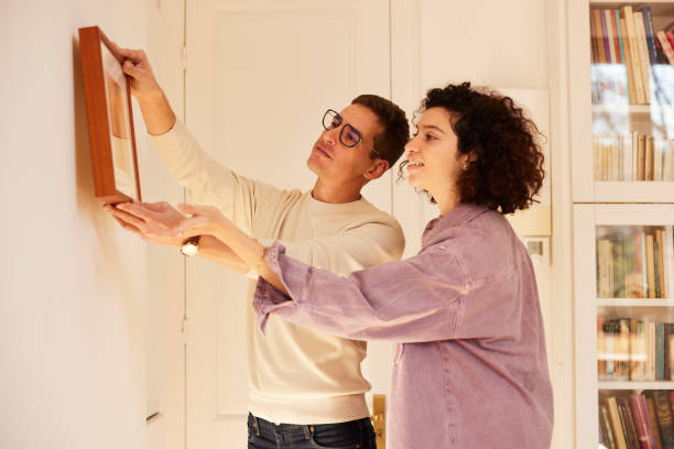 istock Apartment Transformation: Couple Hangs Masterpiece with Pride 1460748728