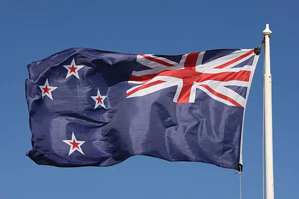 The New Zealand flag flying in bright sunshine