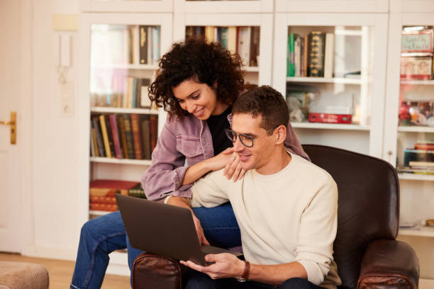 istock Couple Dominates Online Sales from Comfortable Apartment Couch 1460749277