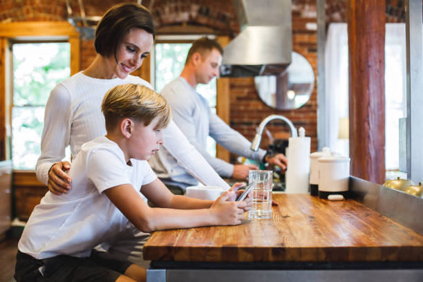 Family hanging out in the kitchen before going to work and school