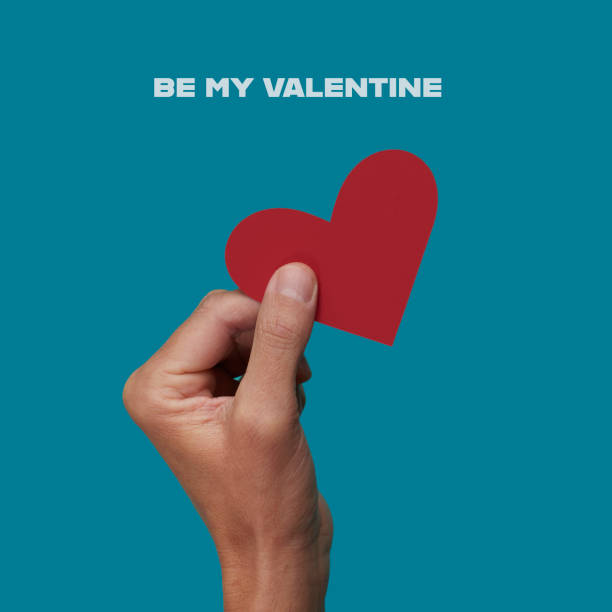istock text be my valentine and man with a red heart 1460752097