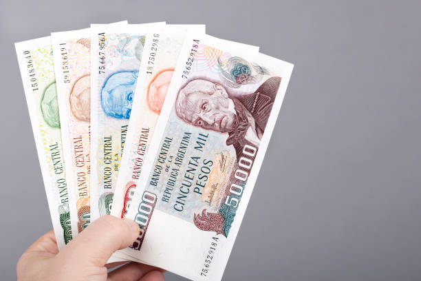 istock Old Argentine peso  in the hand on a gray background 1460752139