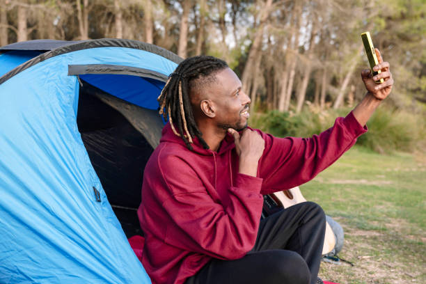 african american man in tent taking a selfie photo