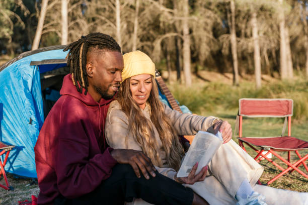 istock a multiethnic couple reading book while camping outdoor 1460752372