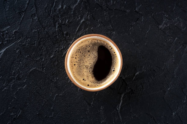istock Coffee cup, overhead flat lay shot on a black slate background 1460753005