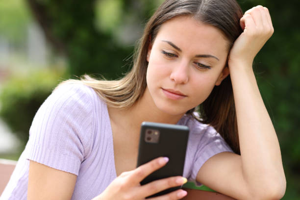 istock Teen reading phone content 1460756725