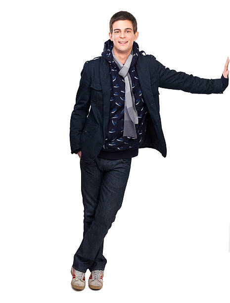 Handsome young man leaning against wall on white background